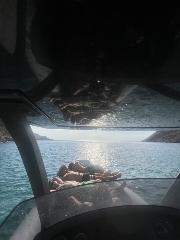 Guests relaxing on the bow with open-sea views